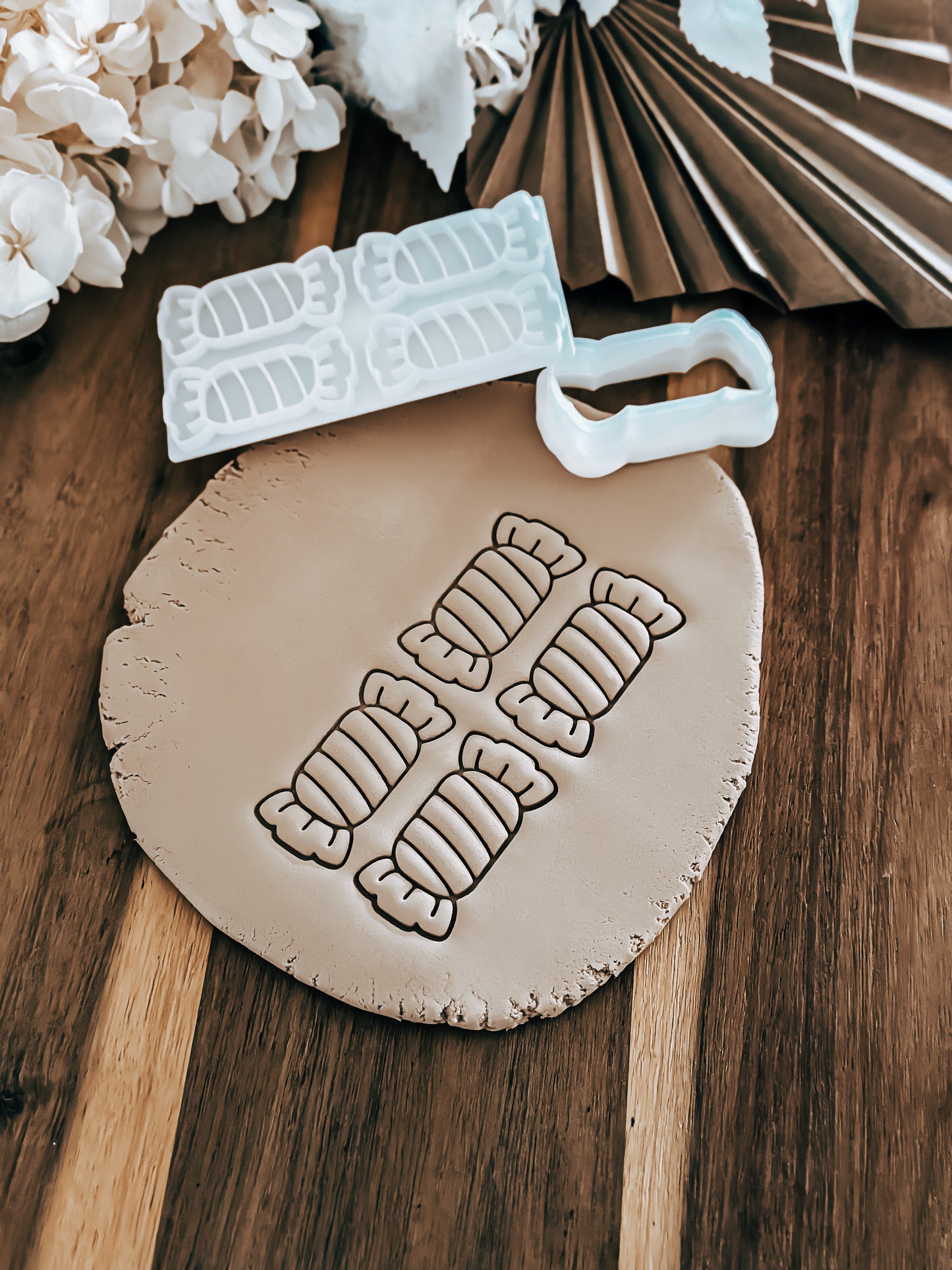 Mini Multi - Lollies Christmas cookie stamp and cutter by O'Khach, shown stamped in fondant