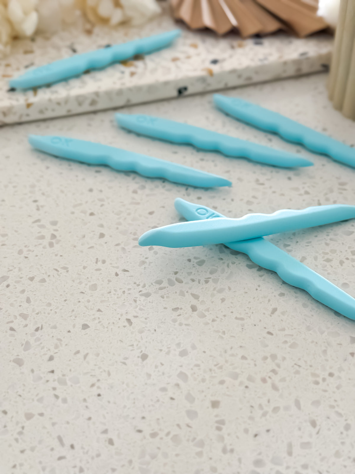 Shape Pro™ fondant tool with curved edges for shaving excess fondant around stamps