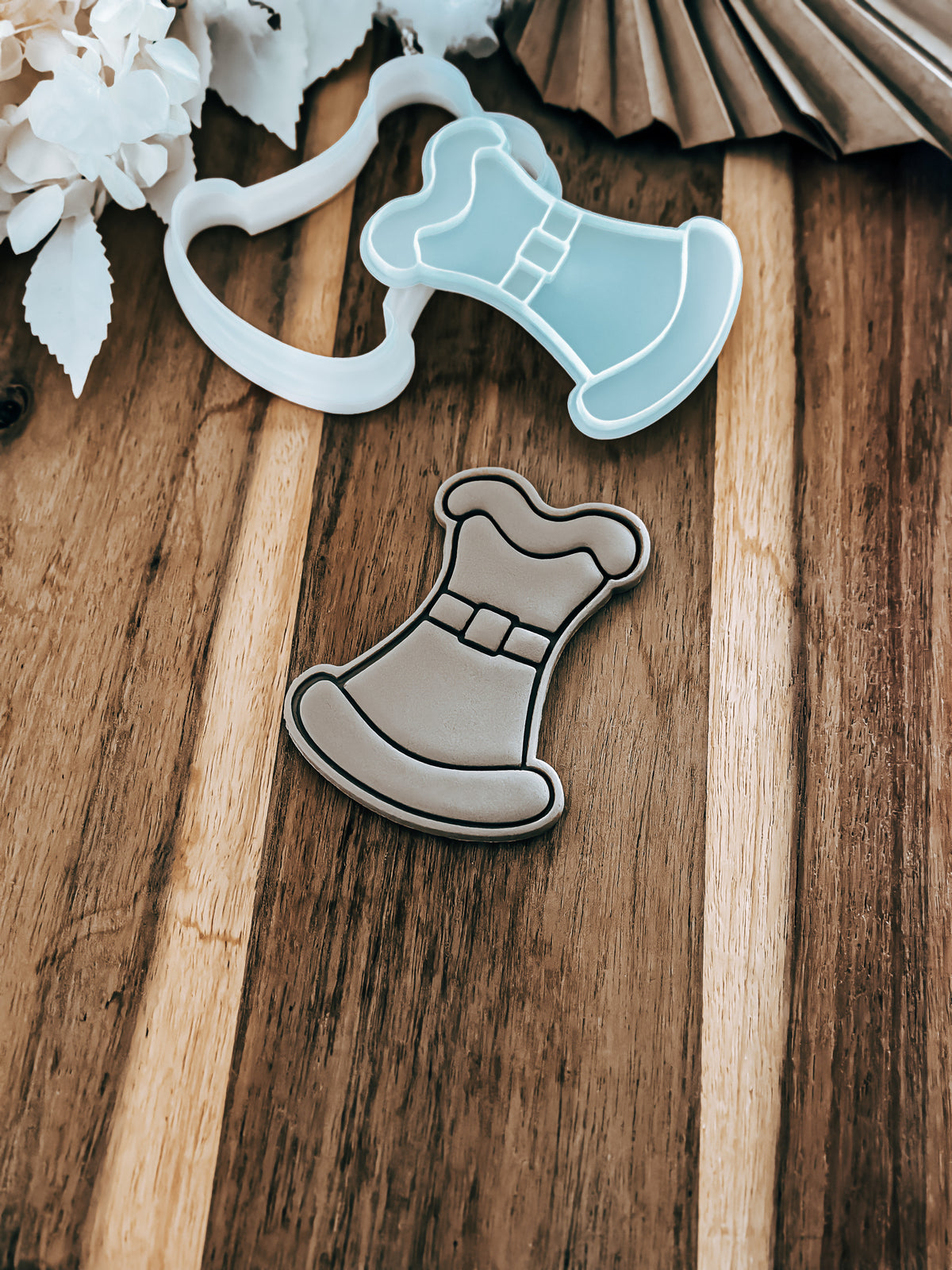 Mrs. Claus Outfit Christmas cookie stamp and cutter by O'Khach, shown stamped in fondant