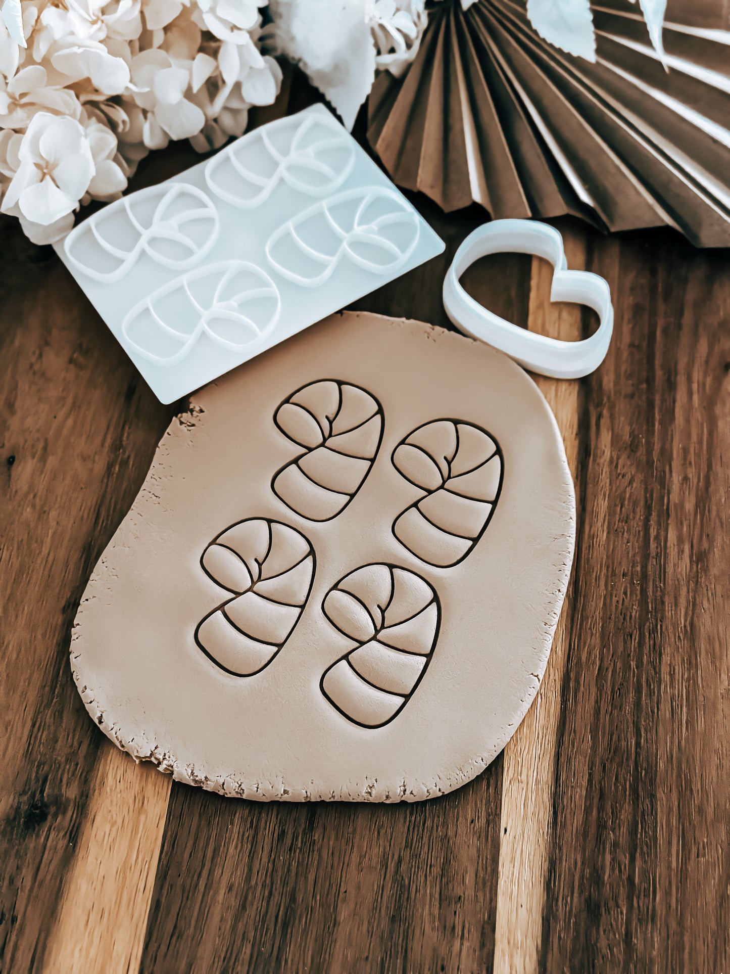 Mini Multi - Candy Cane Christmas cookie stamp and cutter by O'Khach, shown stamped in fondant