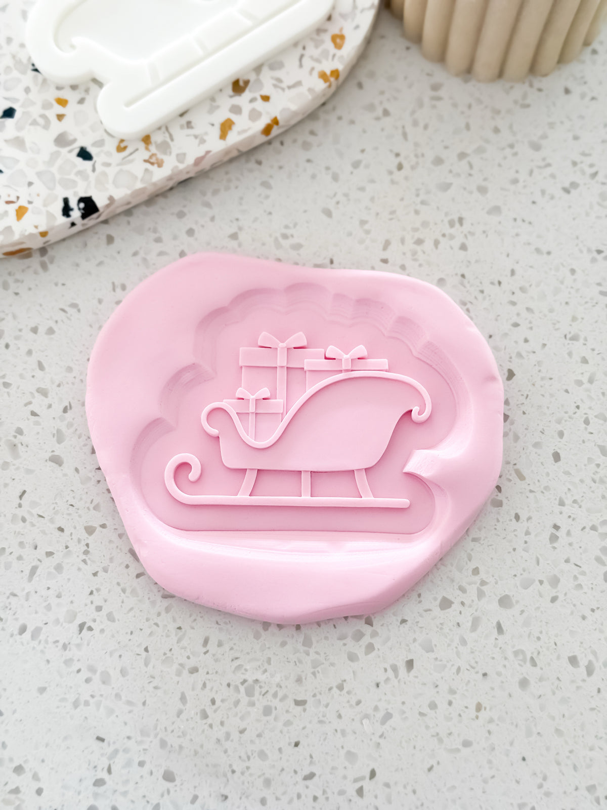 Sleigh (Presents) Christmas cookie stamp and cutter by O'Khach, shown stamped in fondant