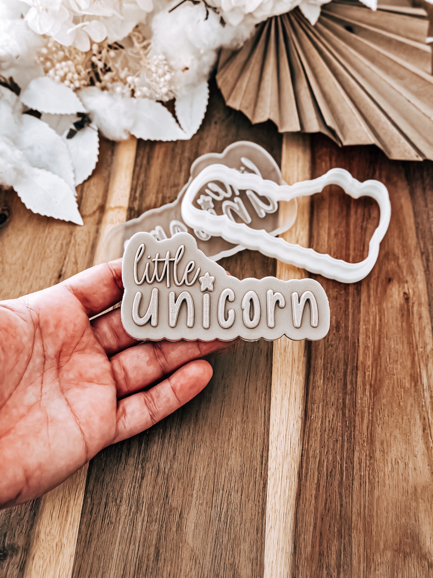 Little Unicorn 'UP' cookie stamp and cutter by O'Khach, shown stamped in fondant