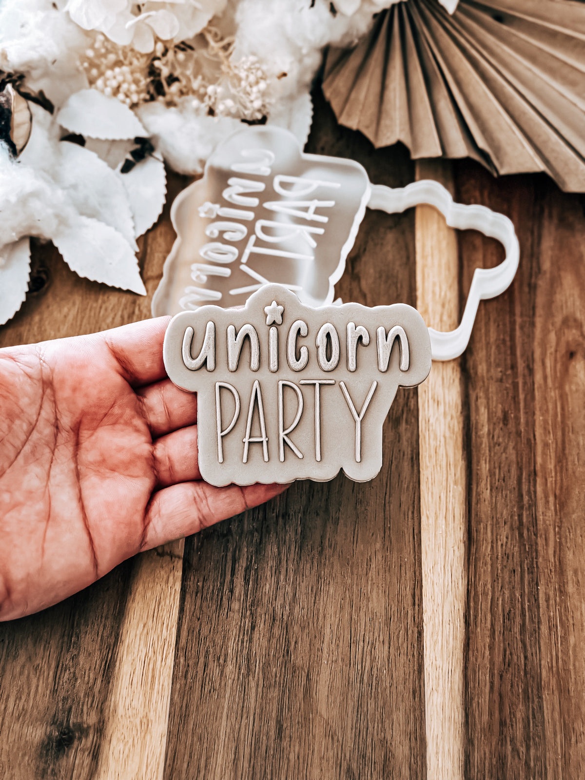 Unicorn Party 'UP' cookie stamp and cutter by O'Khach, shown stamped in fondant