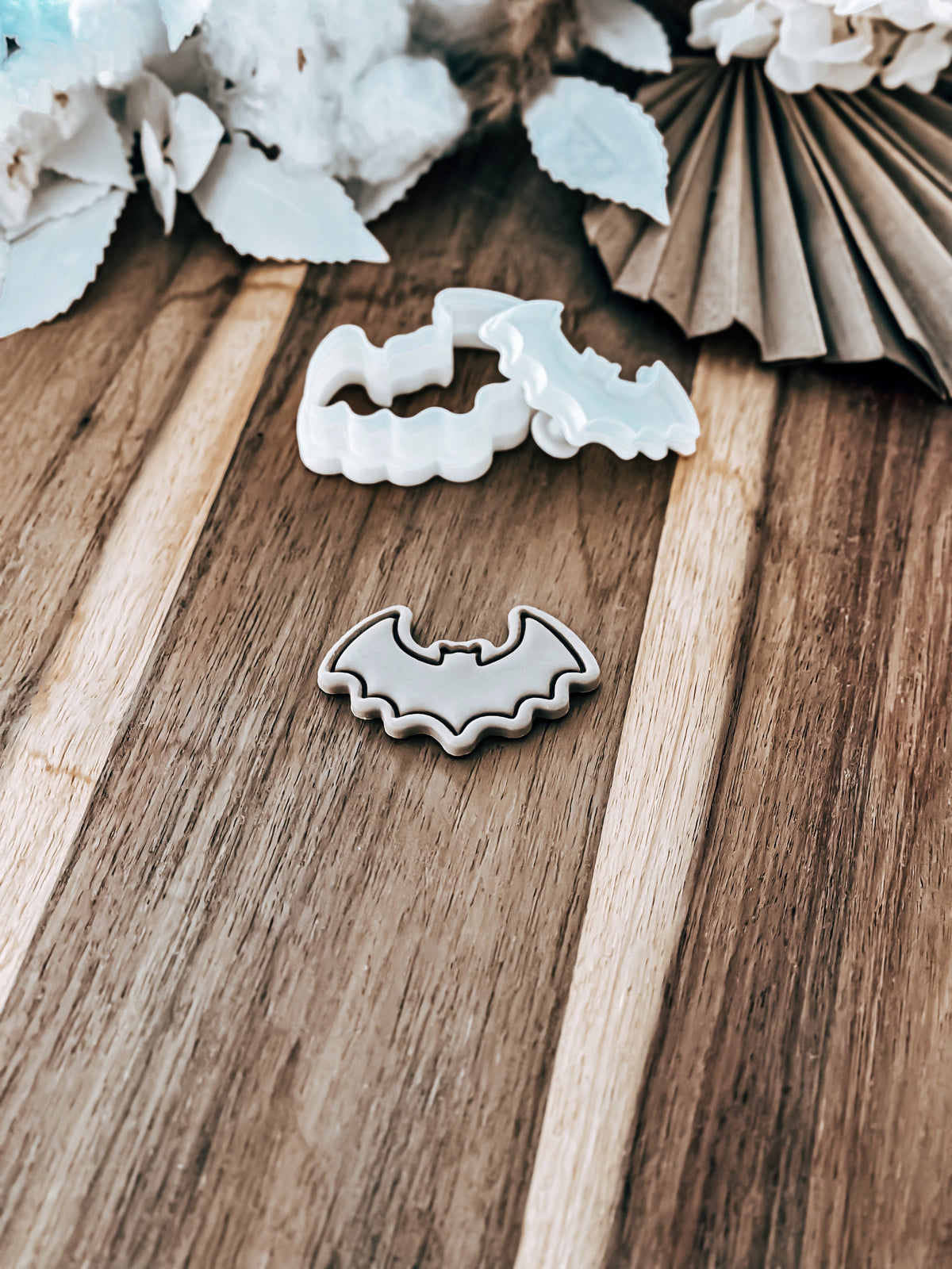 Mini Bat Outline Halloween cookie stamp and cutter by O'Khach, shown stamped in fondant