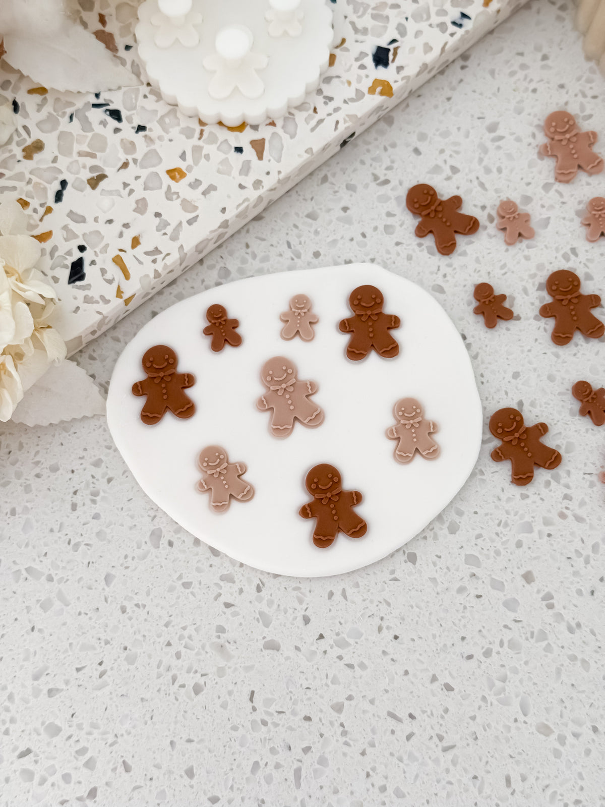 Gingerbread man fondant pieces in brown and caramel made with the Two Tone Press mould by O'Khach Baking Supplies