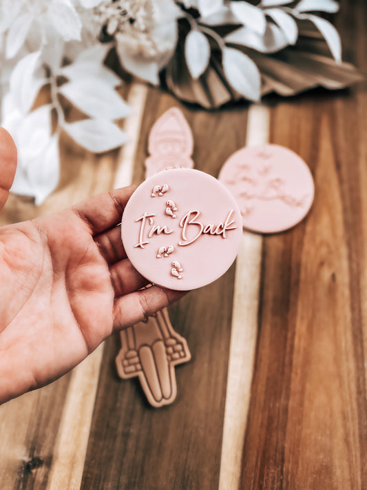 I'm Back 'UP' Christmas cookie stamp by O'Khach, shown stamped in fondant